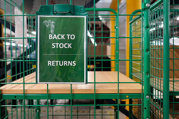 a rack with a sign on it that reads "Back to stock" then a solid line under those words then "Returns"