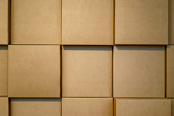 plain brown boxes unevenly stacked on top of one another
